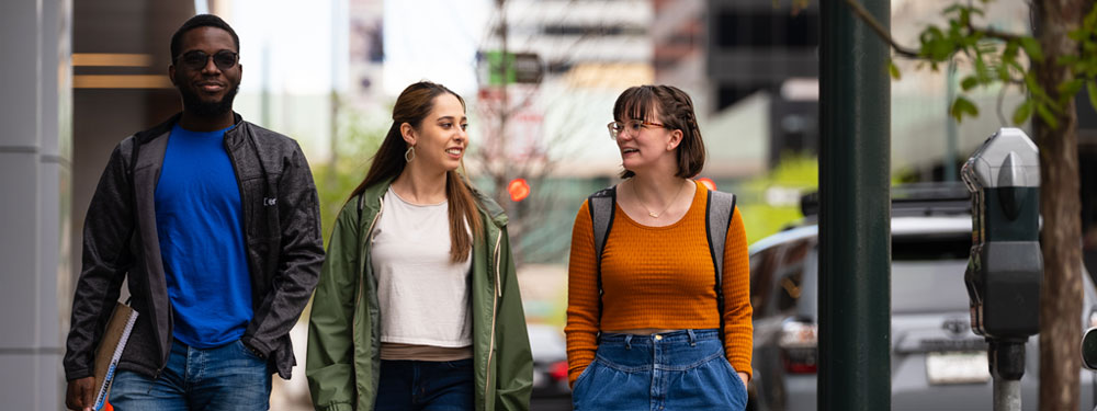 Three CU Denver students walking down street