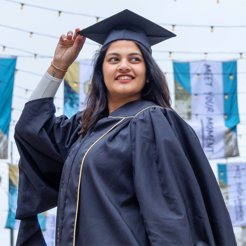 CU Denver graduate with cap and gown