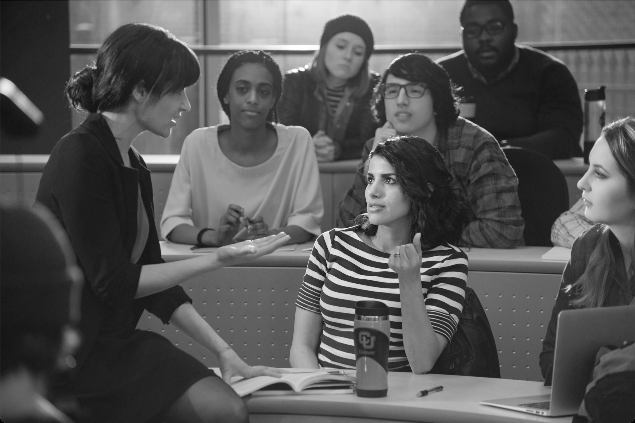 A group of people talking in a classroom