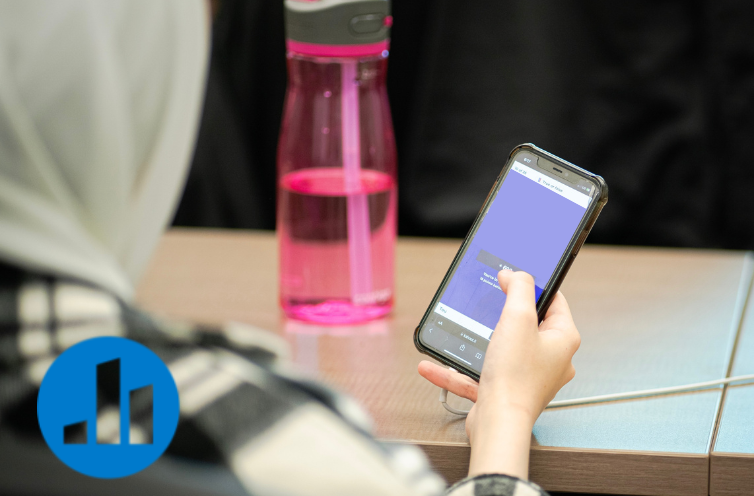 Person on phone participating in Poll Everywhere poll