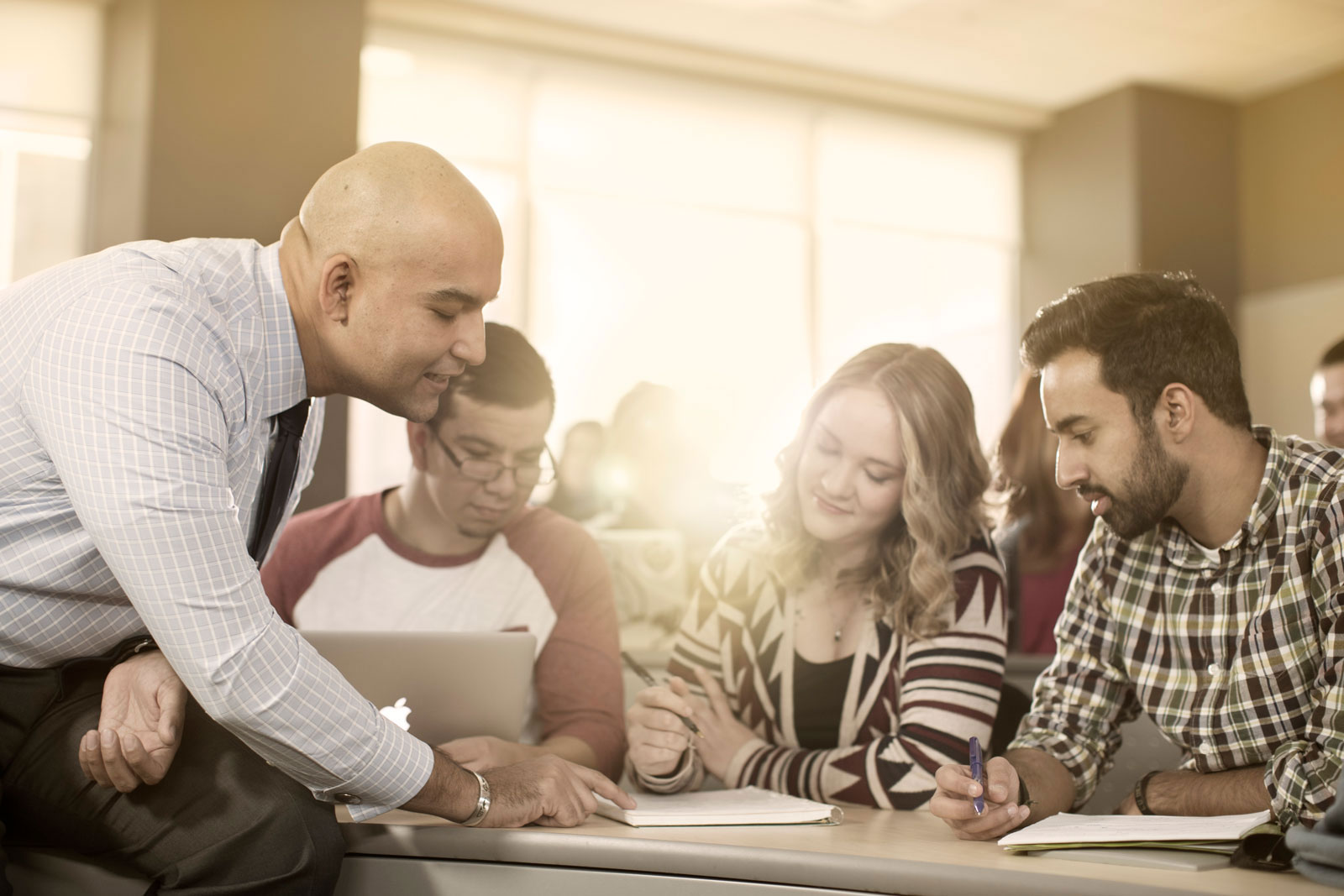 Instructor pointing out something on paper to students