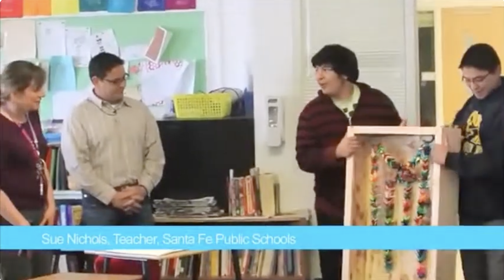 Students holding up an art project they made