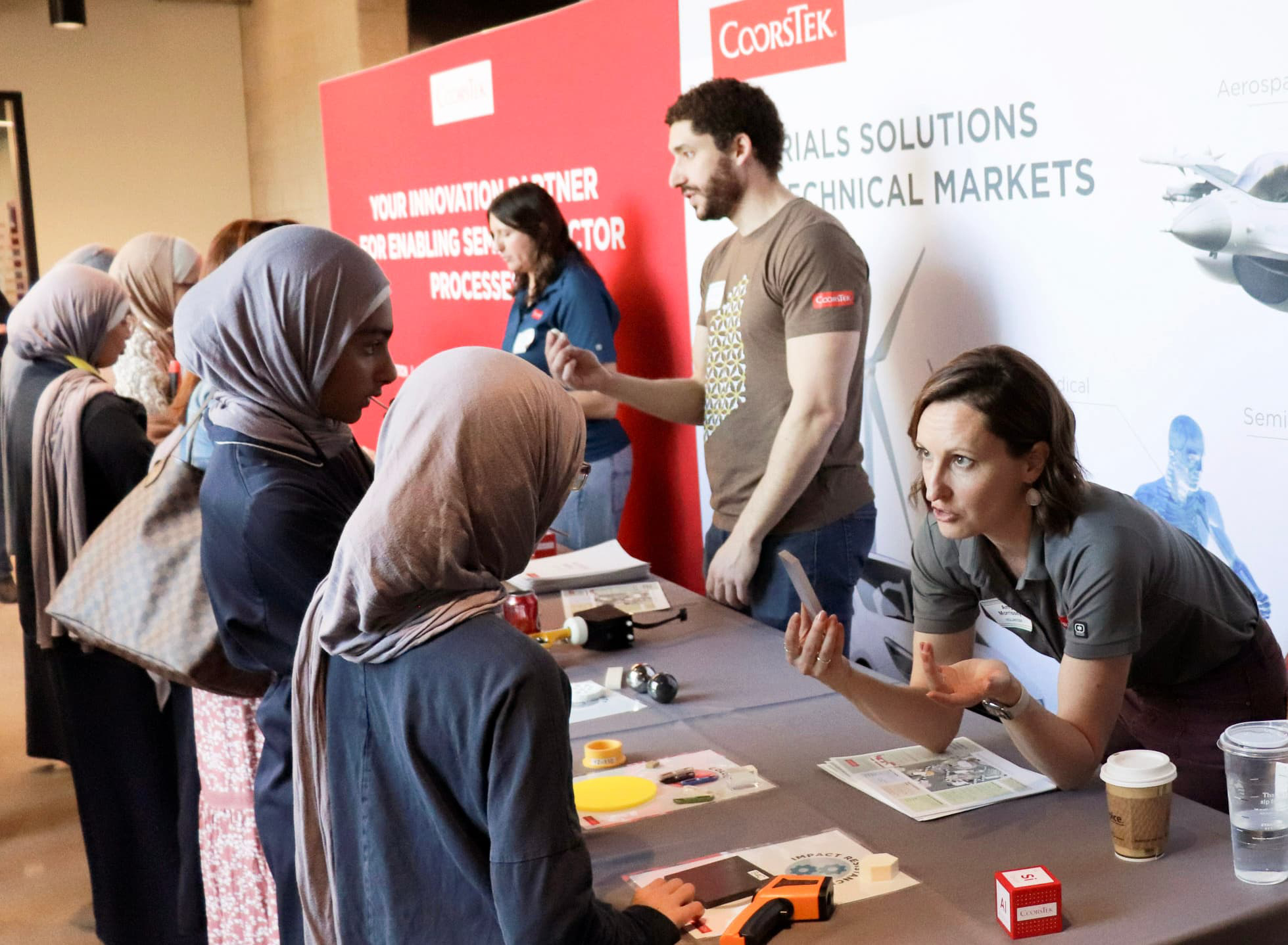 Group of students engaging with CoorsTek representatives.