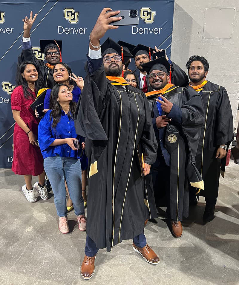 Group of gradates and their families taking a selfie.
