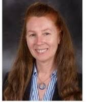 headshot of Caroline Van Howe smiling in business casual attire