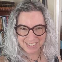 Close-up headshot of Marjorie Levine-Clark from neck up smiling.