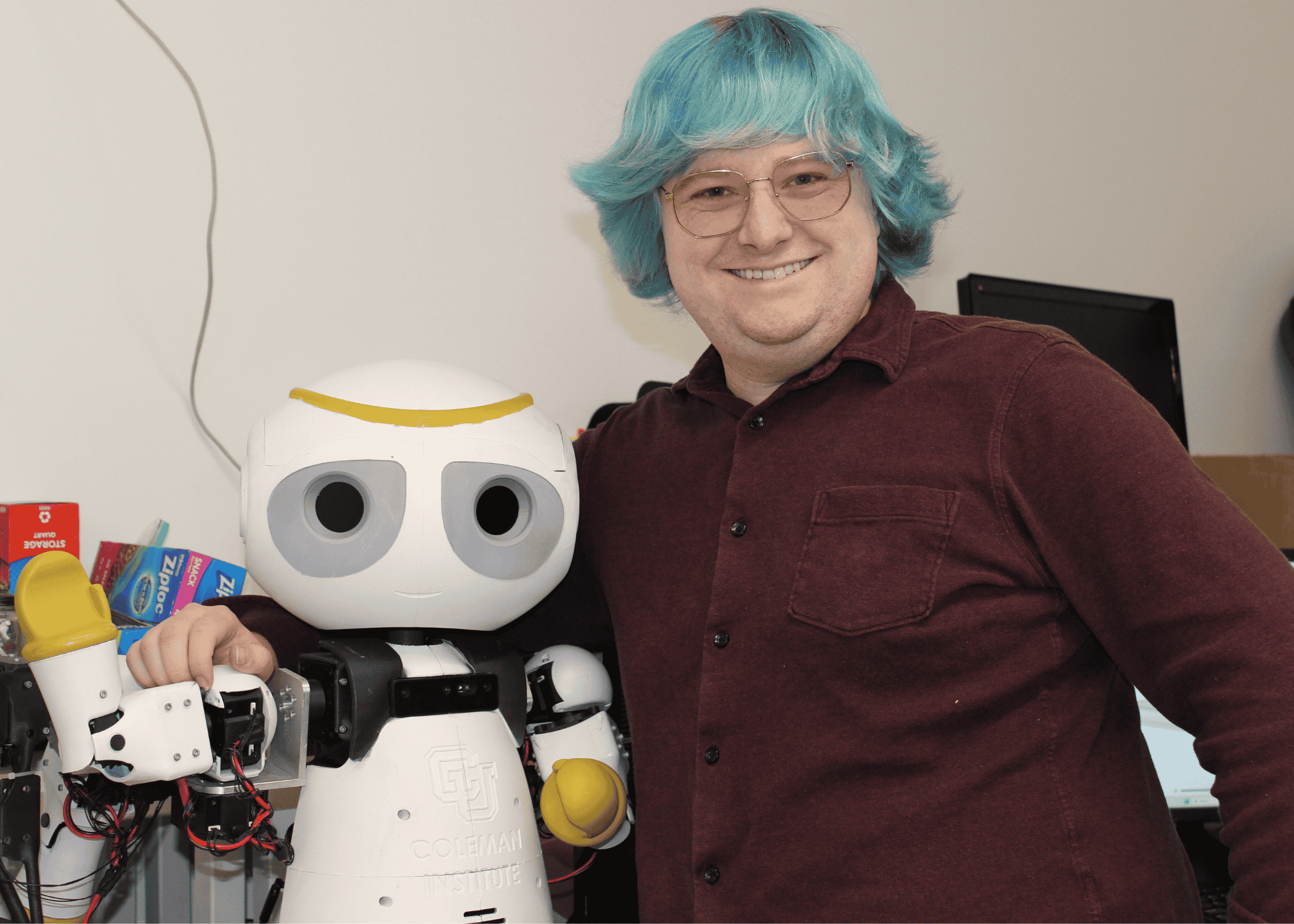 Student Jack Leuck poses with Social Assistive Robot SMILE-i